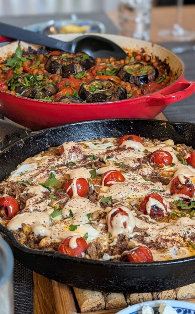 Pans of musaqa'a and braised eggs with lamb, tahini and sumac 