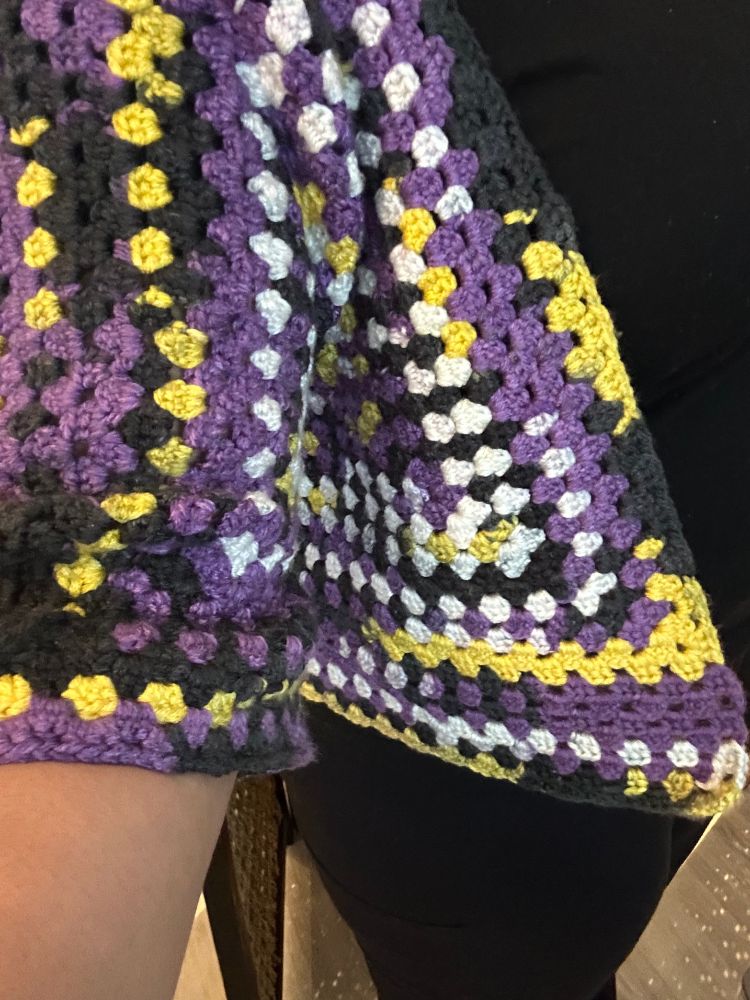 Close-up of partially completed crochet hexagon sweater in the nonbinary colorway from JoAnn's house brand Big Twist.