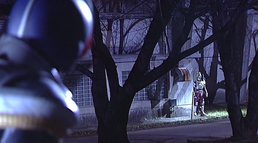 A scene from the end of episode 1 of Kamen Rider Blade. Kamen Rider Blade stares at Kamen Rider Garren off in the distance as he fights the Locust Undead. I mean, Kamen Rider Garren stares at Kamen Rider Blade as he does nothing. I suppose both of these things are true. 