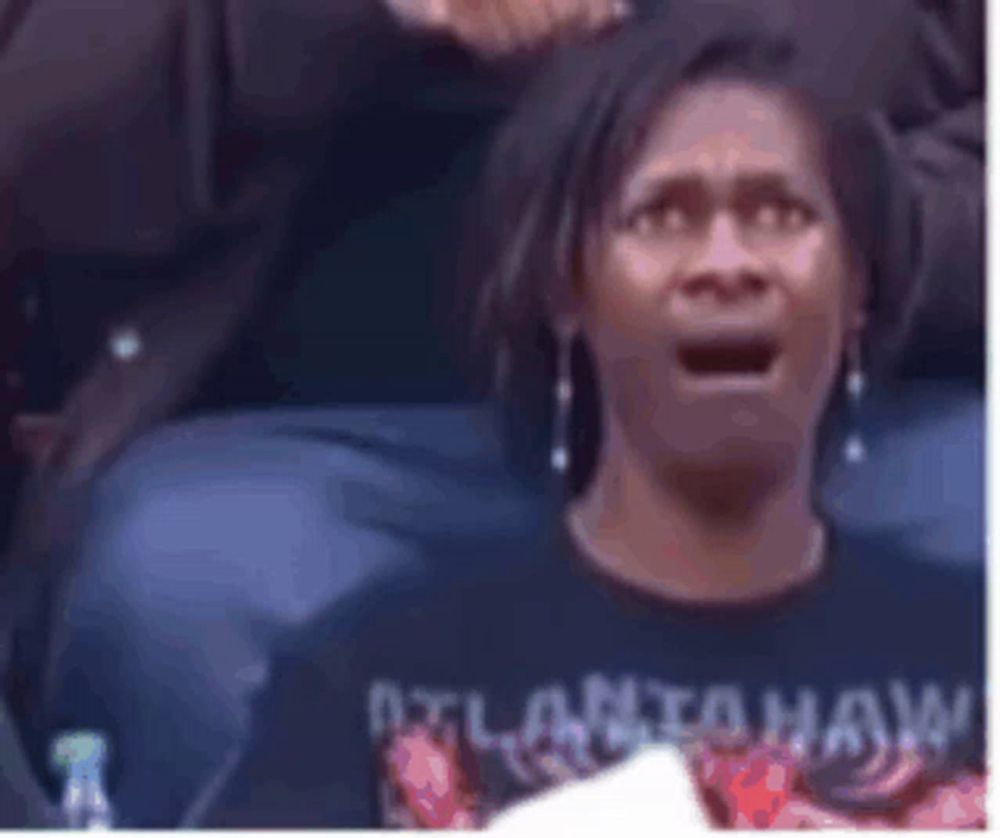 a woman wearing a black shirt that says atlanta on it is screaming