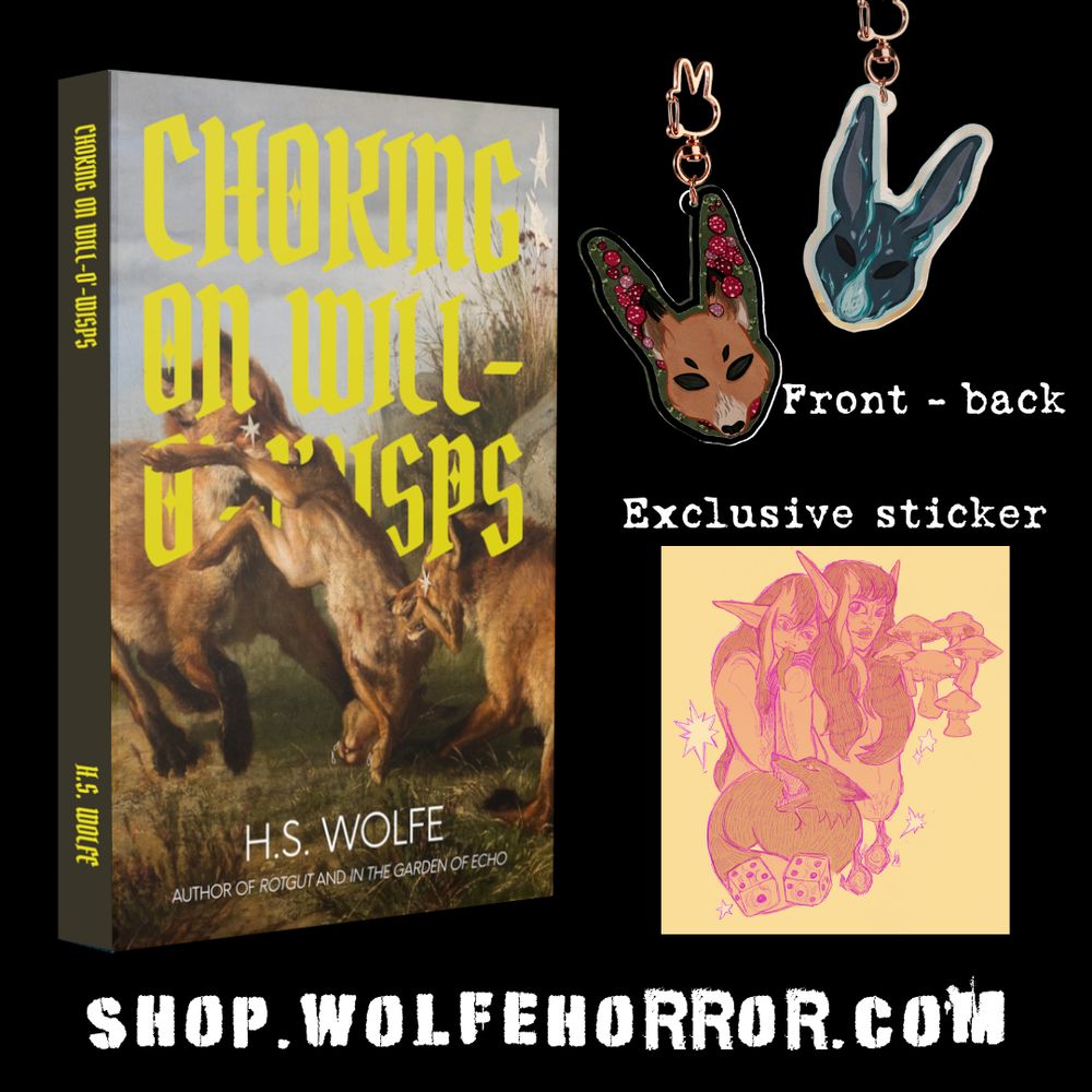 Examples of the merch, a yellow sticker and a double sided fox and rabbit charm 
