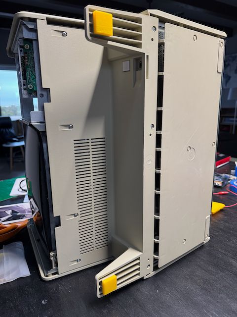 Apple Lisa resting on its side, sporting some new fancy yellow front feet.