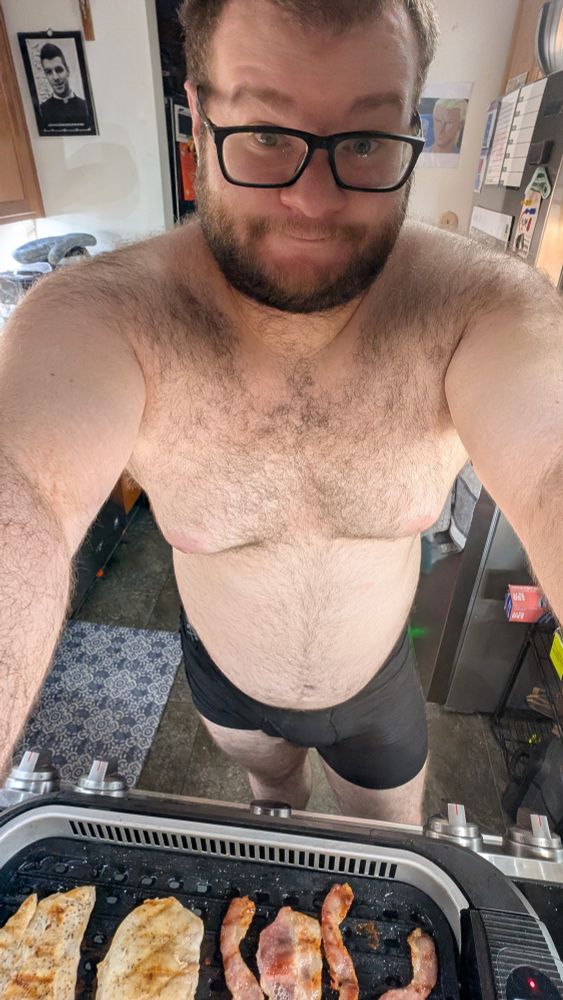 A cub in his undies making chicken sandwiches.