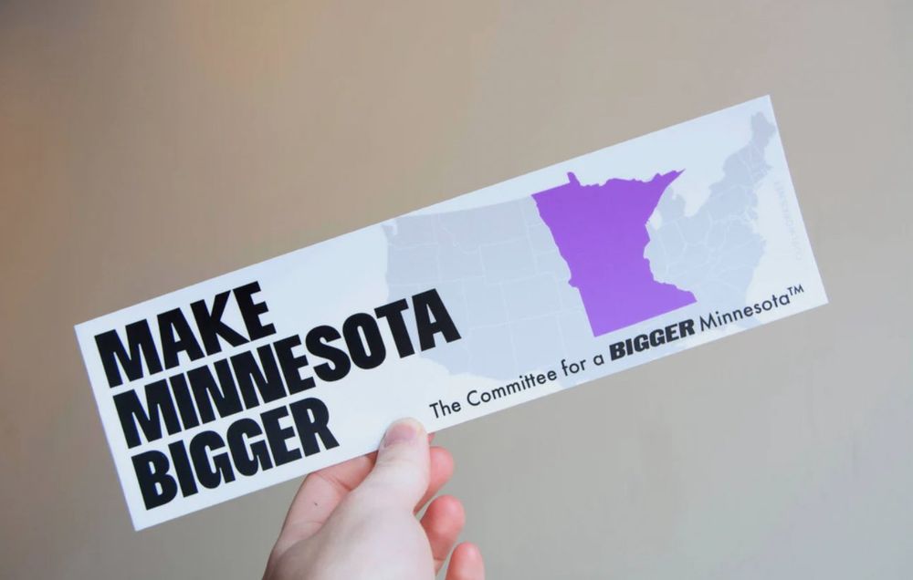 Bumper sticker depicting a enlarged Minnesota with the text “Make Minnesota Bigger”