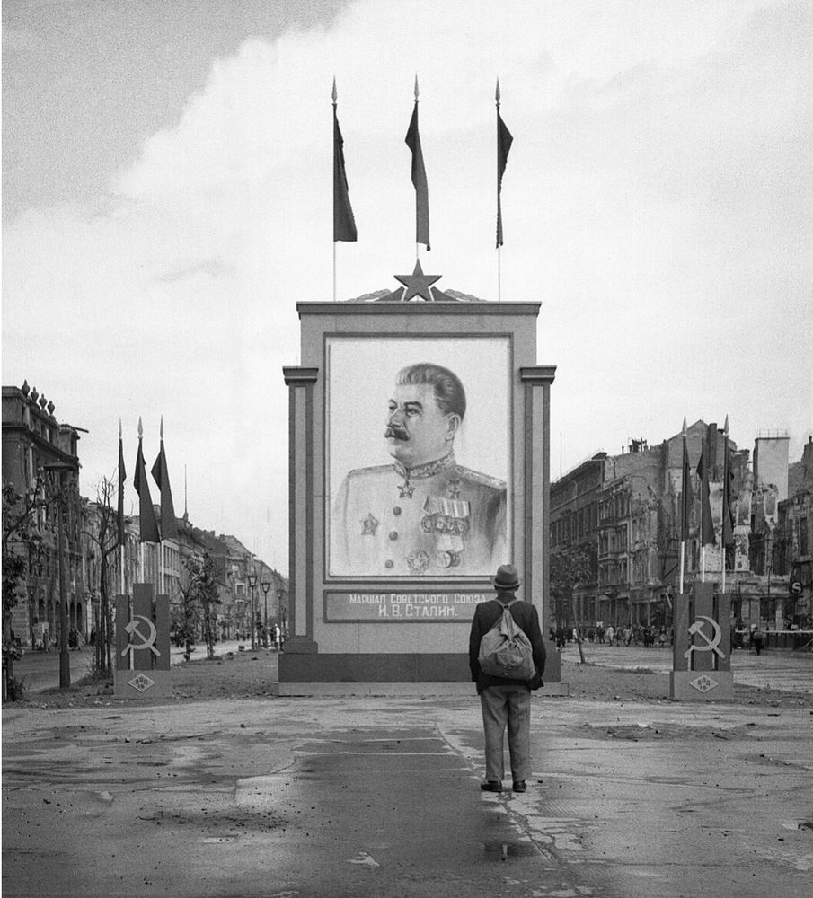 A German civilian looks at a large poster portrait of Stalin on the Unter-den-Linden in Berlin, 3 June 1945