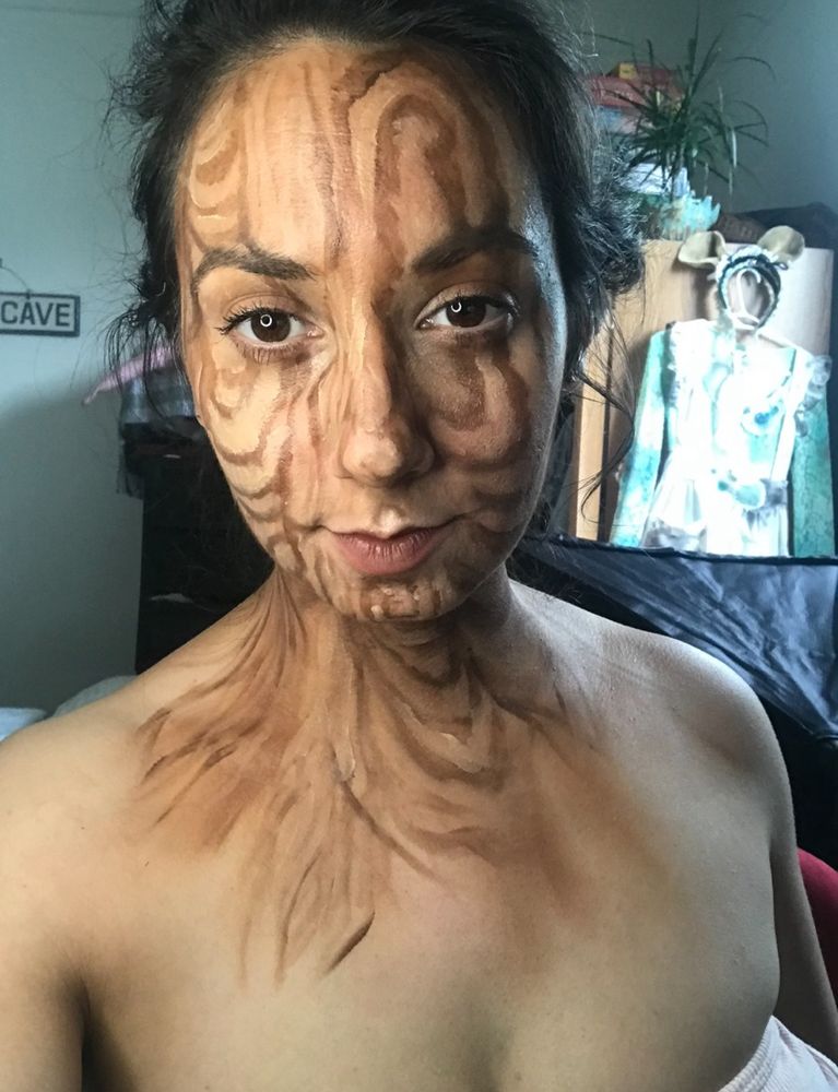 Woman looking at camera with makeup that makes her look like a tree. Cosplay 