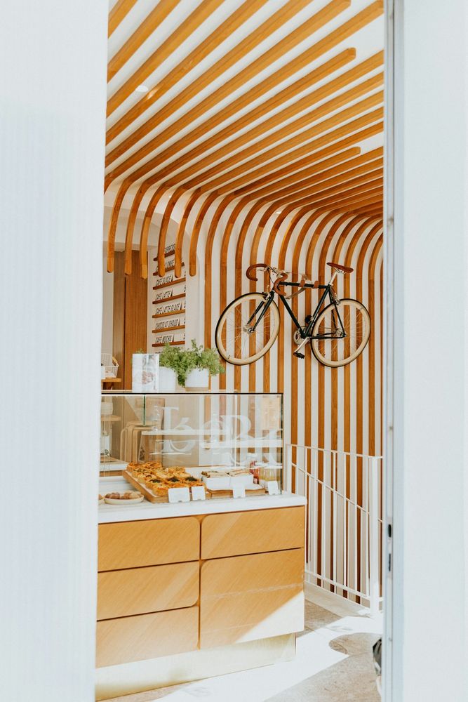 A bike hanging from the ceiling of a store