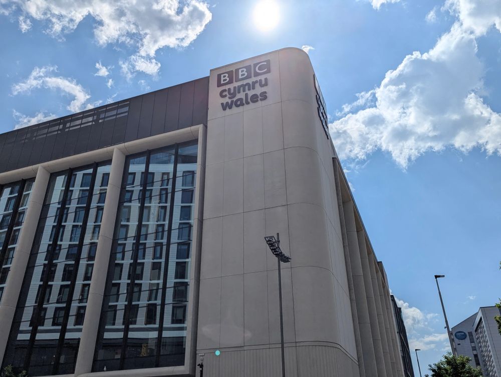 An image of the Central Square building in Cardiff. The BBC Cymru Wales branding is prominently displayed.