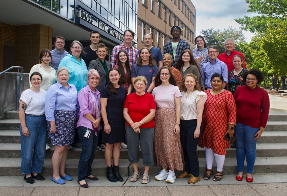 Group photo of the RRCHNM team, standing in three rows on steps with nine people in the front row, nine people in the middle row, and seven people in the back row.
