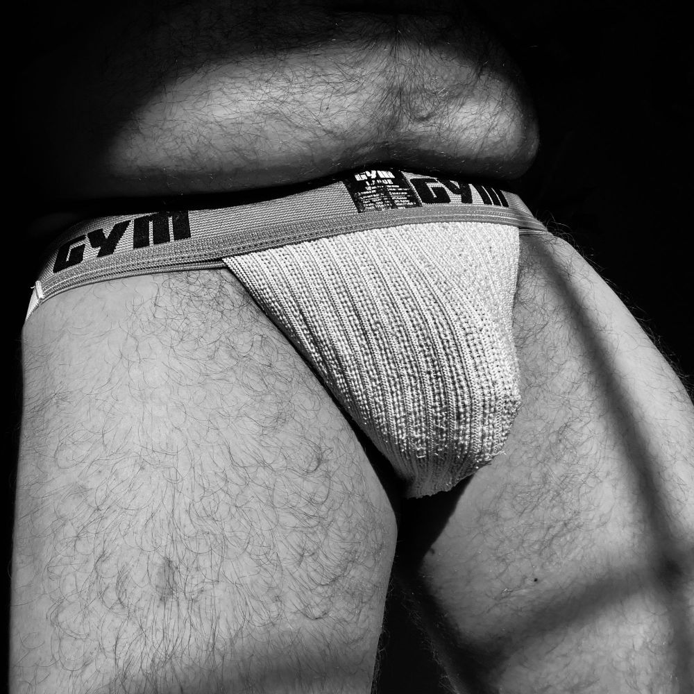 black and white photo of a chubby man's mid section in a Gym jockstrap