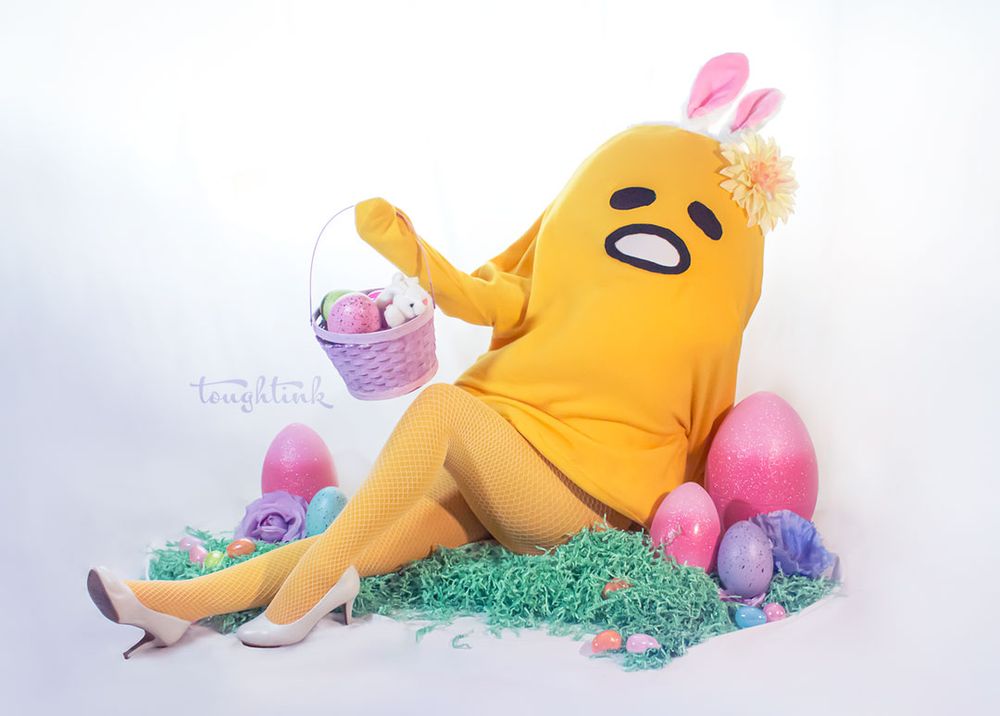 photo of a cosplay of easter gudetama with an easter basket, colorful eggs, easter grass, and fishnet legs.