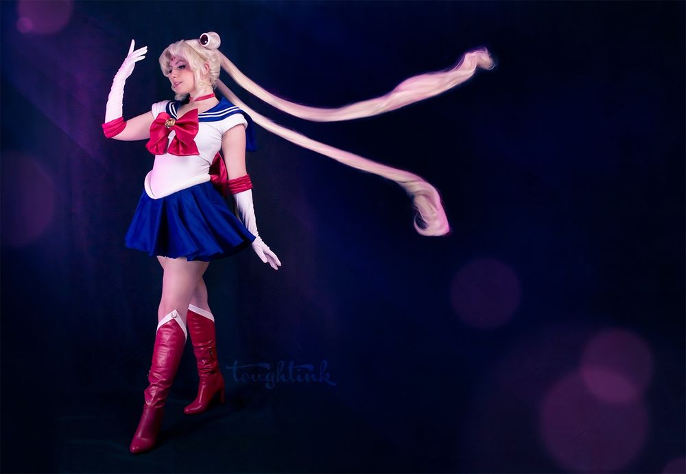 woman cosplaying sailor moon with her twin tails flying out behind her