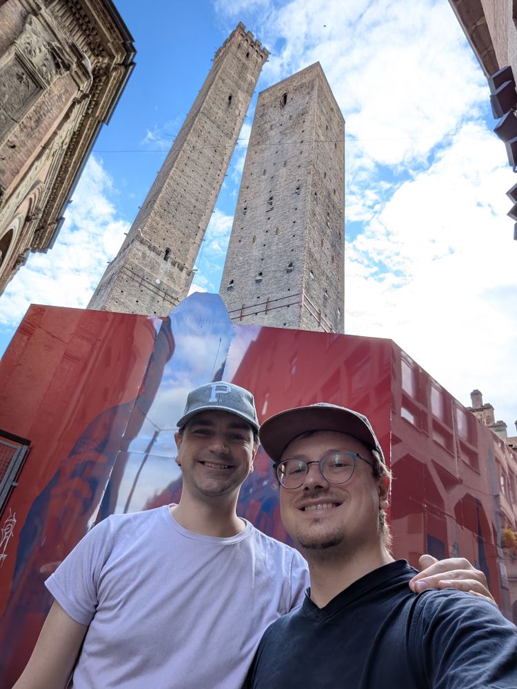 Myself and Lukas posing for a selfie in front of the two leaning towers in Bologna.