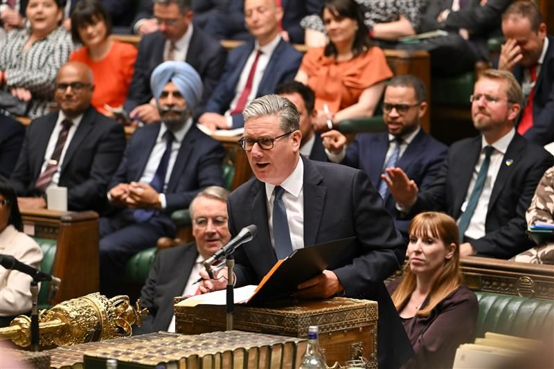 Prime Minister Sir Keir Starmer standing in the House of Commons. With MPs sitting in the background. 