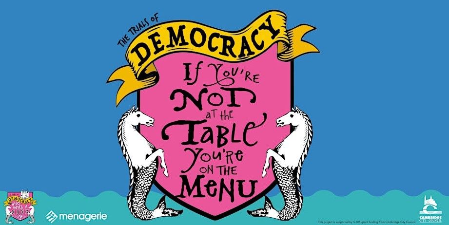 Logo for "The Trials of Democracy: If You're Not at the Table, You're on the Menu." It features a pink and gold shield with two white seahorse-like creatures on either side, all set against a blue background.