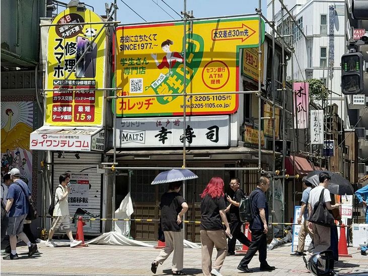 Scaffolding erected around a row of shops fronting Waseda Dori, and running alongside the Seibu Shinjuku line.