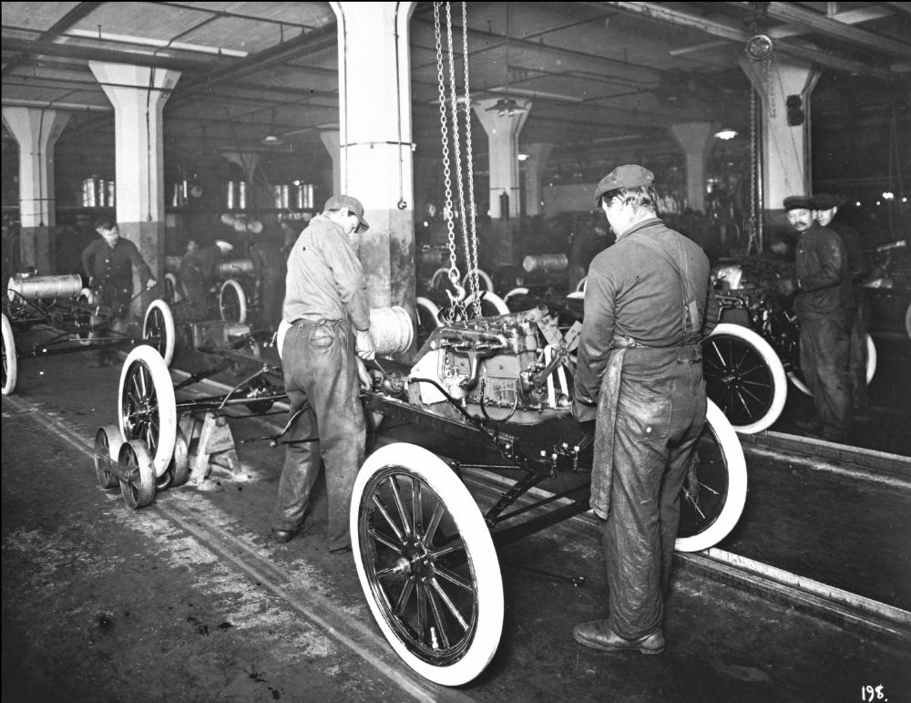 Engine being mounted to a chassis on the Ford assembly line.