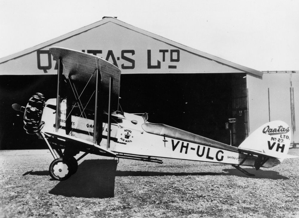 Early Quantas biplane in front of a Quantas Ltd hanger.