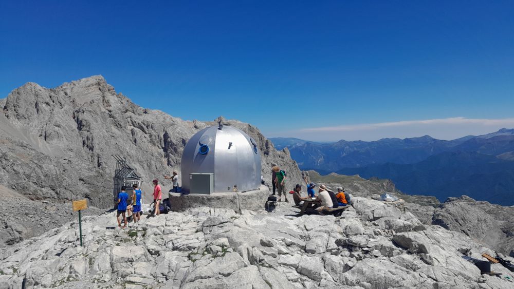 The exterior of refugio Cabana Veronica in the Picos de Europa in Spain. A silver gun turret among rocky mountains