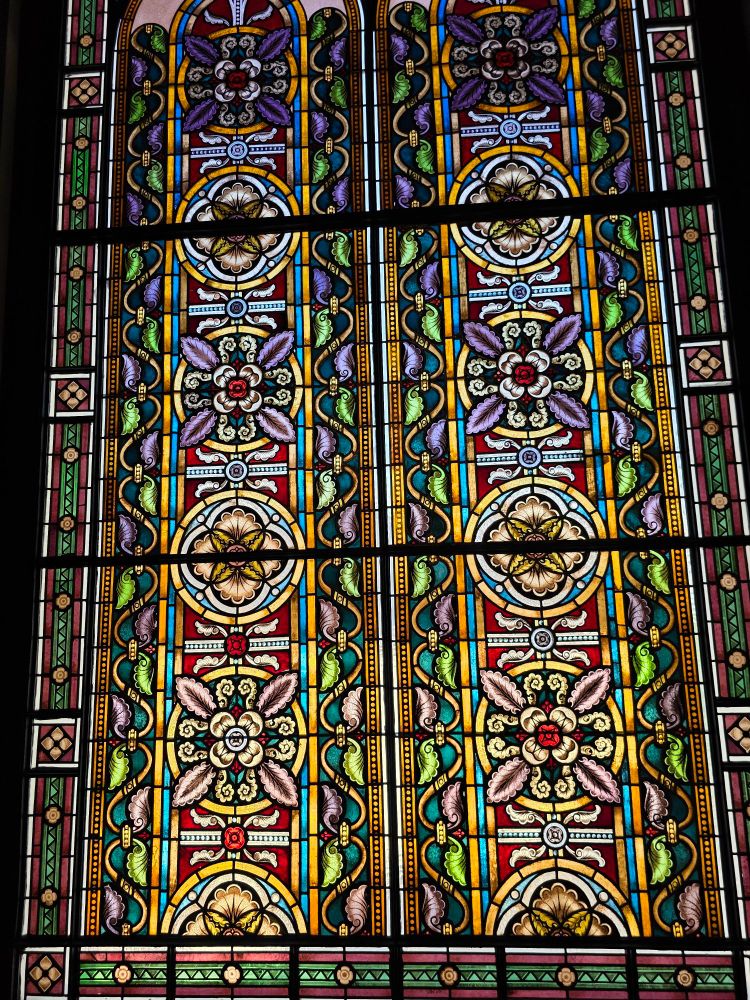 A stained glass window with geometric patterns.