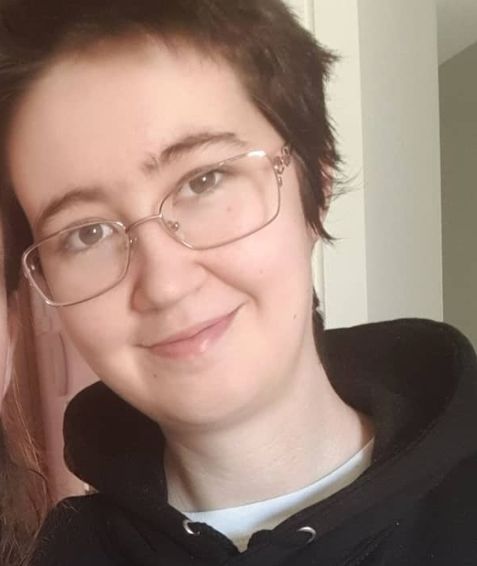 woman with a short pixie cut and glasses