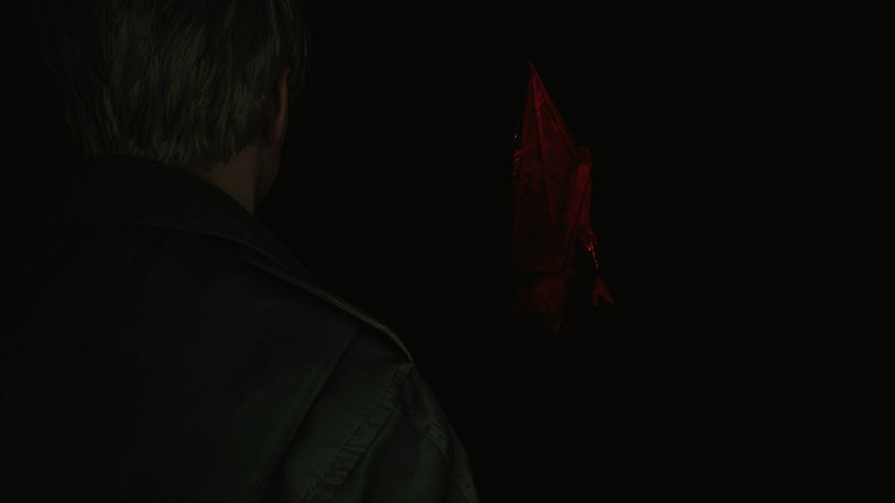 James of Silent Hill 2 in the dark facing Pyramid Head.