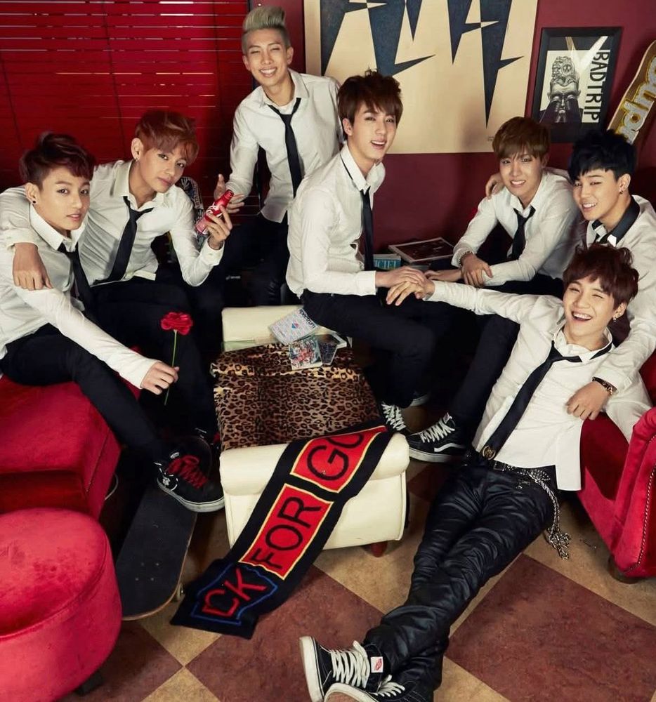 BTS members wearing white shirts with black ties. Group shot in their early years. 