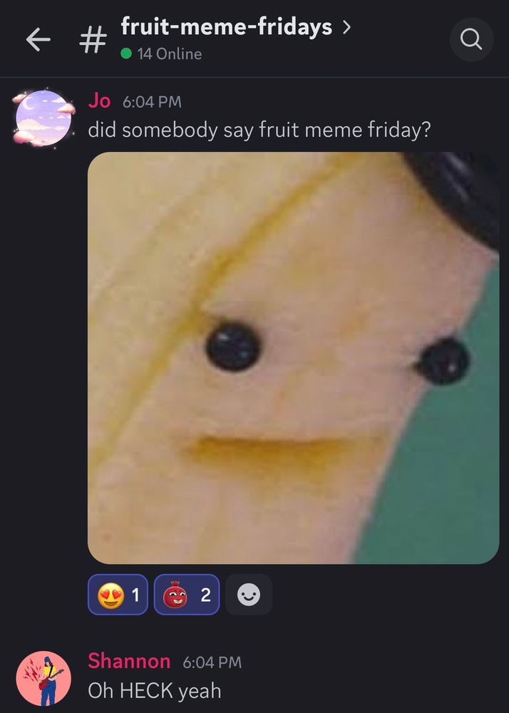 A screenshot from the Fruit Golf Discord. The name of the channel, “fruit-meme-fridays” is at the top of the screenshot. There is message from a user names Jo that reads: “did somebody say fruit meme fridays?”, followed by a picture of a banana with eyes. There is another message from a user named Shannon that reads: “Oh HECK yeah”. 