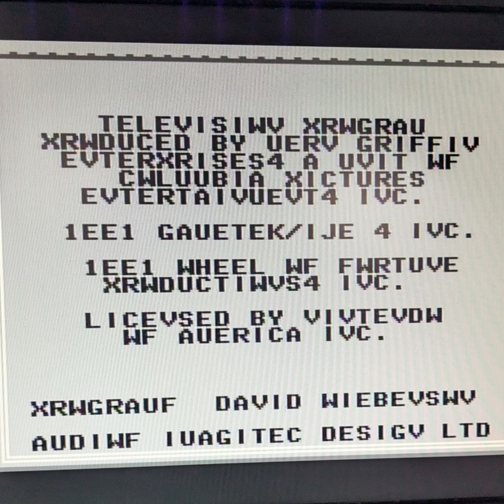 "Wheel of Fortune" NES game credits but all of the text is garbled, showing things like "Televisiwv Xrwgrau".