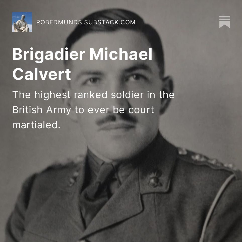 A picture of a young army officer in formal military uniform. He has four stars on the epaulettes on his shoulders and his tie is neatly made. He is clean shaven but for a clipped moustache. His hair is short and pomaded in some kind of wax. He is looking beyond the camera with an inscrutable, fixed expression.