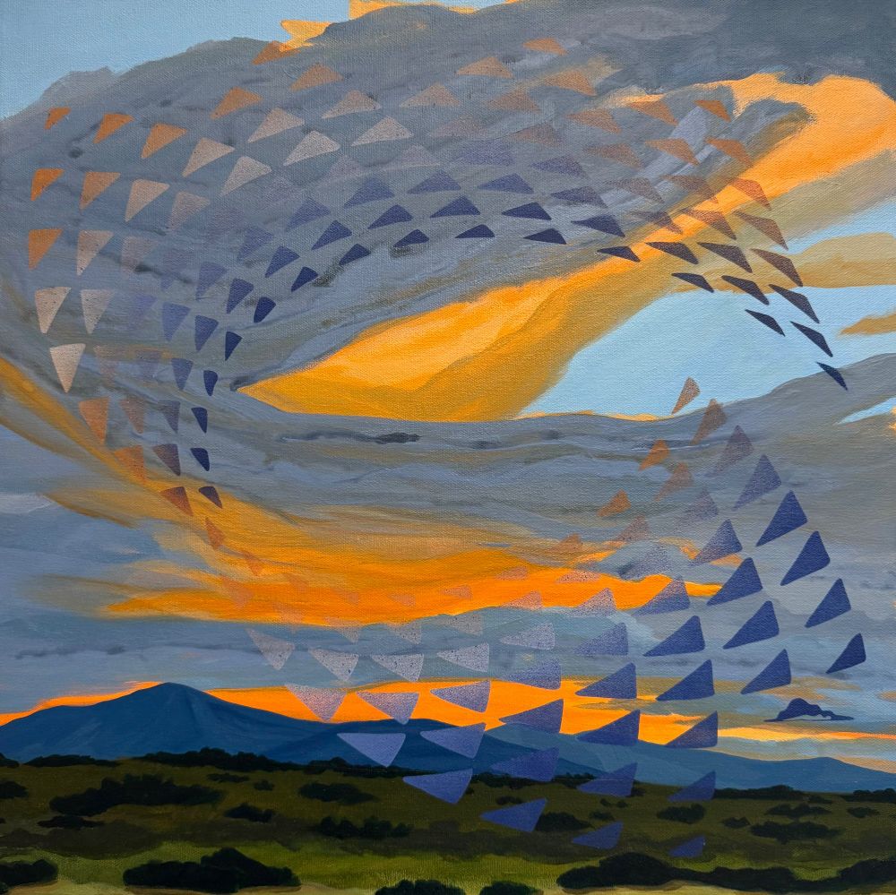 A swirl of triangle patterns against a glowing orange cloudy sky over a high desert landscape.