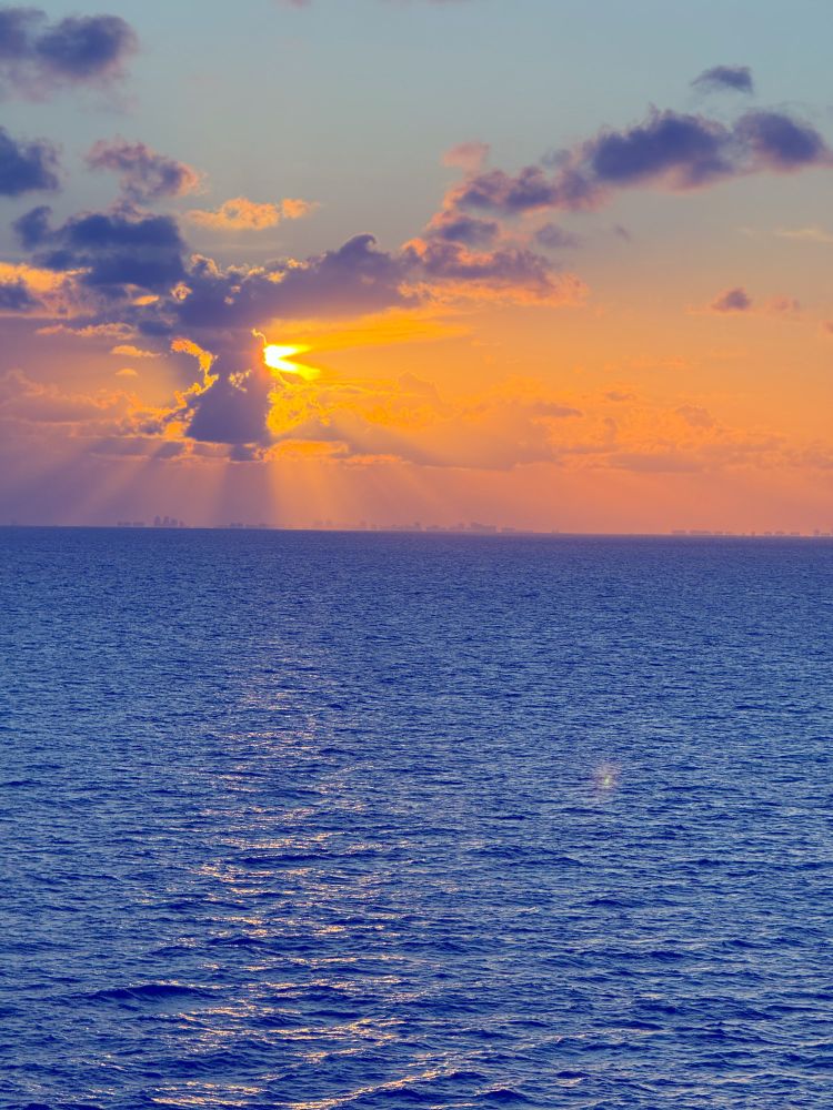 Sun peaking through clouds over Miami/Fort Lauderdale while on the Atlantic. 