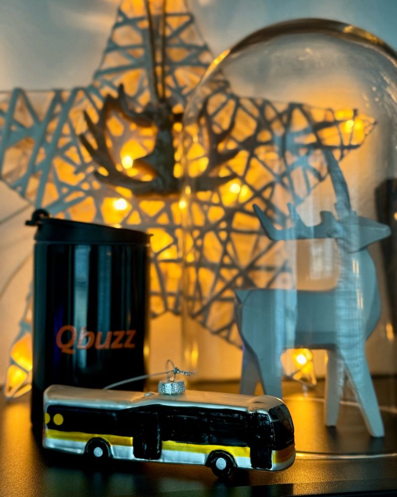 Qbuzz thermoskan beker en een kerstbal in de vorm van een bus van Qbuzz.