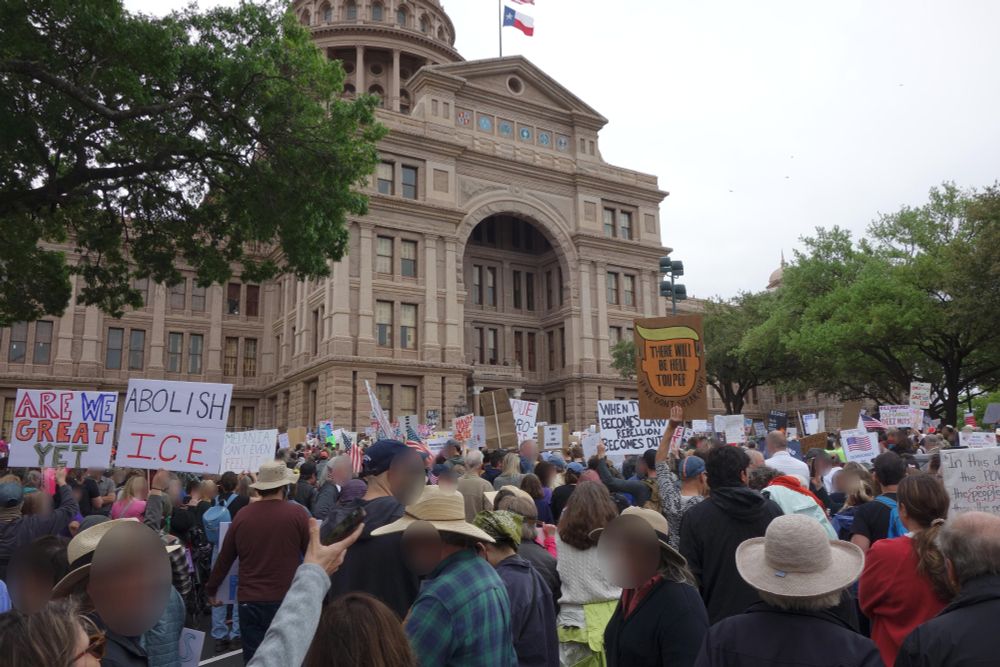 A crowd of protesters in front of the Austin capitol building