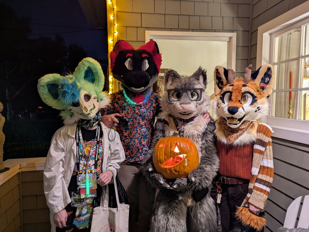 chemfyre, mílur, me, and hazel all in fursuit on Halloween