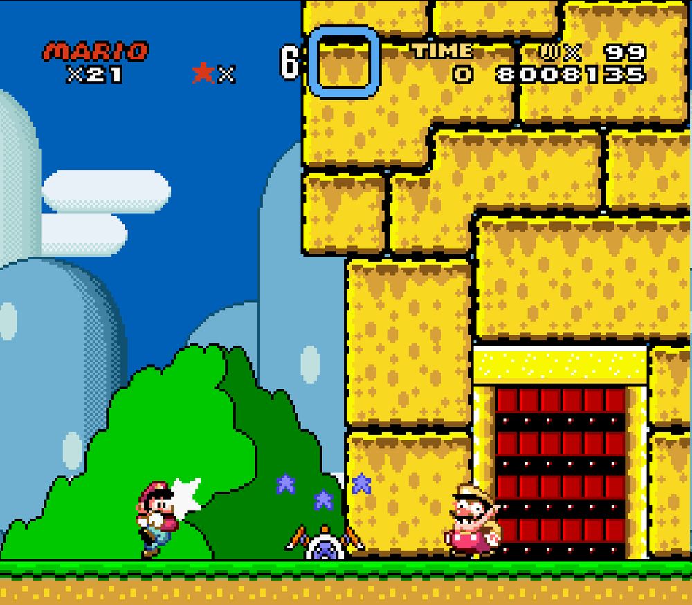 A mockup screenshot of Super Mario World for the SNES. Mario is outside of Iggy's Castle, with Wario standing in front of the door to the castle. Wario's face is slightly cross-eyed, similar to his appearance in Super Mario Land 2. Iggy Koopa is half-buried in the ground between Mario and Wario. The castle has been painted a gaudy golden yellow color, and the door has red wood in place of the usual brown color.