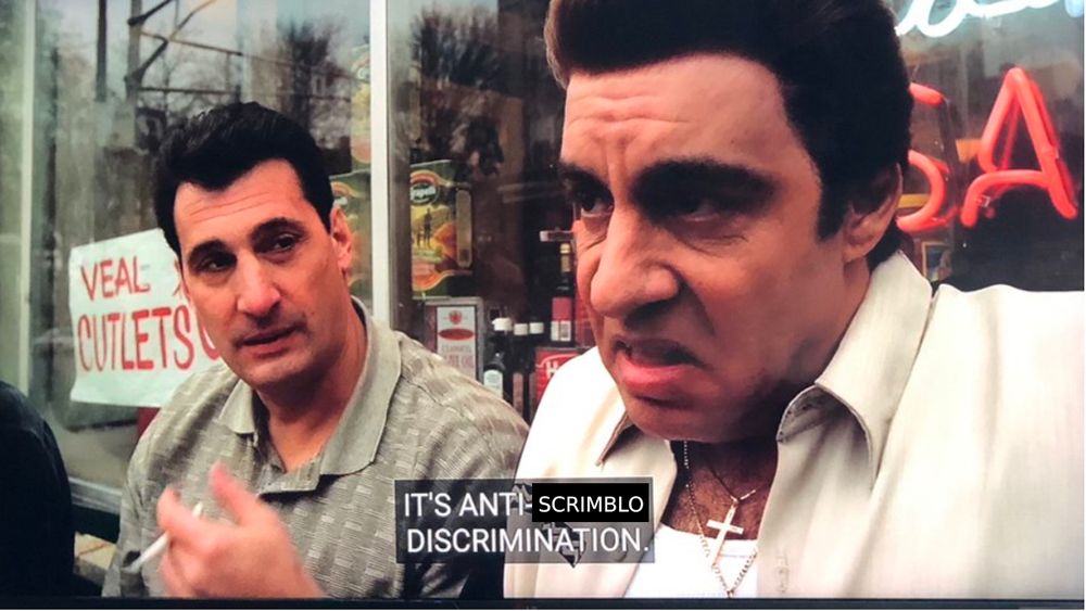 Silvio Dante from the Sopranos sitting outside of a restaurant, stating 