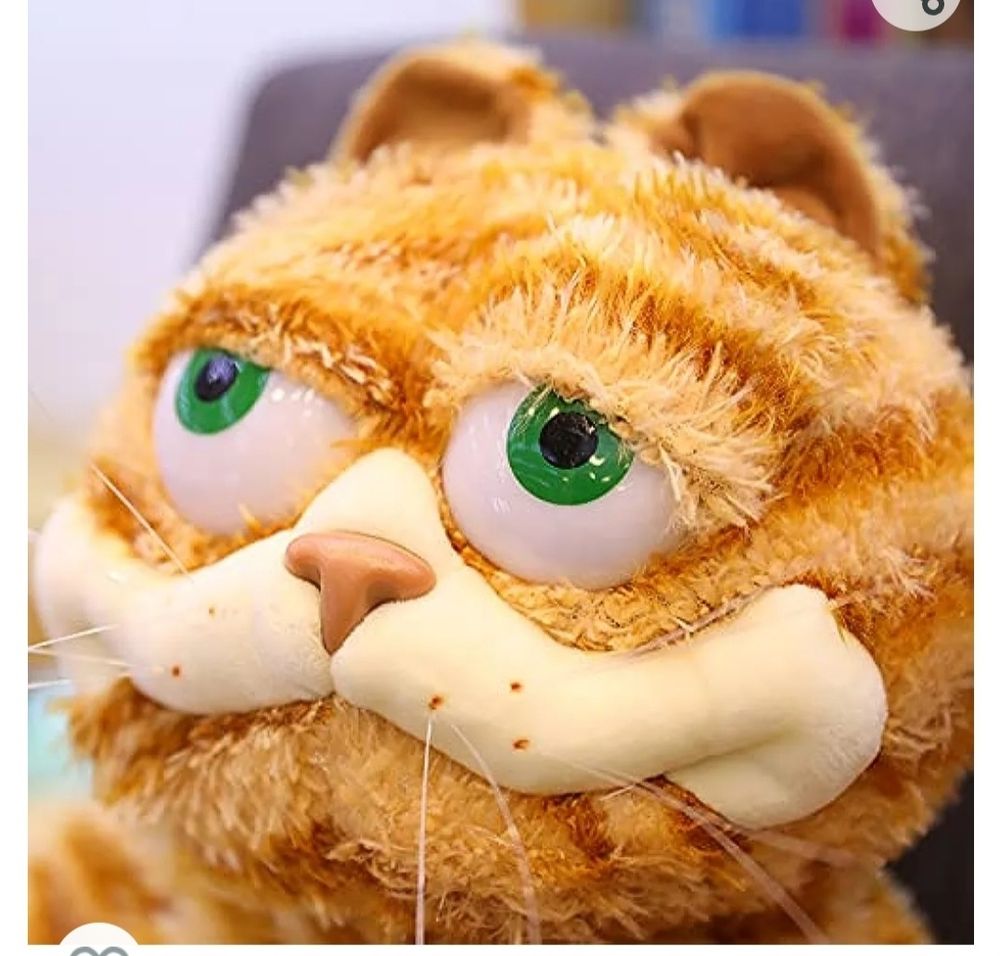 Gorfeld. 

Gorfeld is similar to garfield, sure. But something isn't quite right. His eyes are different, off. Unlike Garfield, he feels an unwelcome presence to consume lasagna with, or ponficate about the wretched trickery of the date of Mon. Monday. No, Gorfeld instead laments the tragedy of Wednesday. Gorfeld is different. Perhaps made in the image of Garfield, Gorfeld has been molded into his own cat. His eyes ajar, ready to face the cruel world. A smile on his face. But is it happiness or fright? Is he ready for what awaits? Do his green eyes see what awaits him? Do they see the bitter end? Perhaps Gorfeld is a teller. Lamenting Mondays won't make them fade. Lasagna is a good treat, but we shouldn't eat it all the time. TV is welcome, but gorfeld urges a book. Gorfeld knows the horrors of the world, yet uncanny as he is, works to ensure others enjoy the moments. Thank you, Gorfeld. You may not be garfield, but you are a welcome friend. 