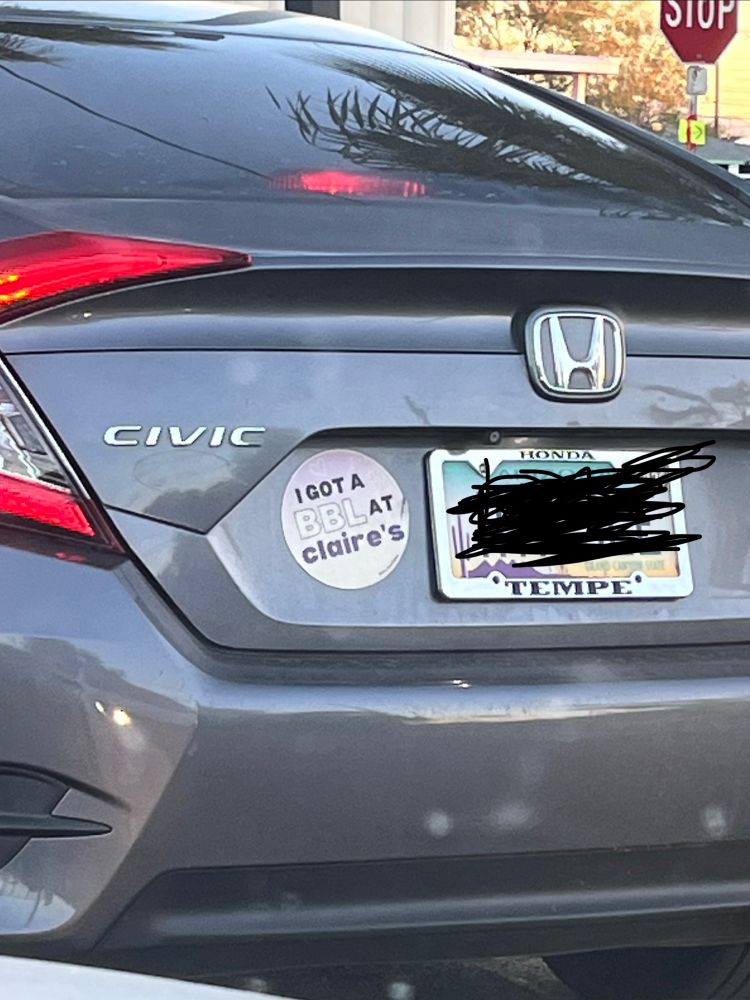 A car with a large bumper sticker that says “I got a BBL at Claire’s”