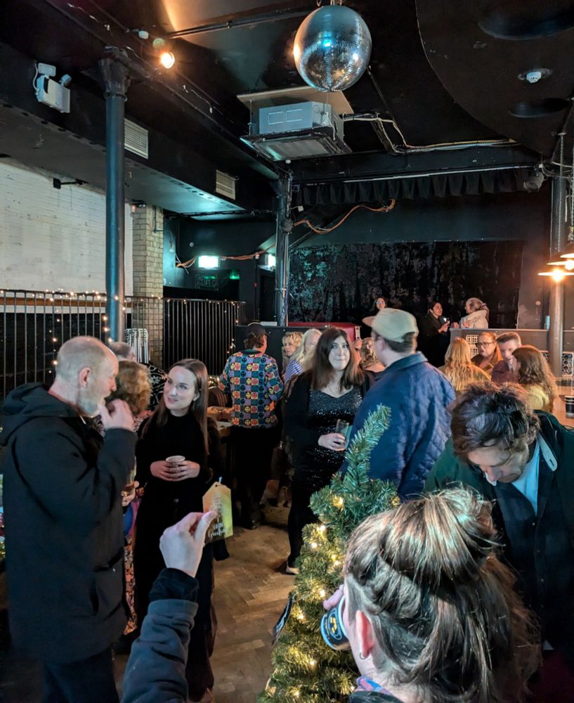 wide shot of the space with people making connections 