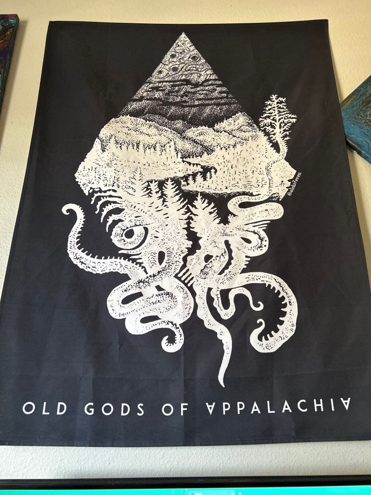 hung flag from the podcast Old Gods of Appalachia. white print on black canvas.