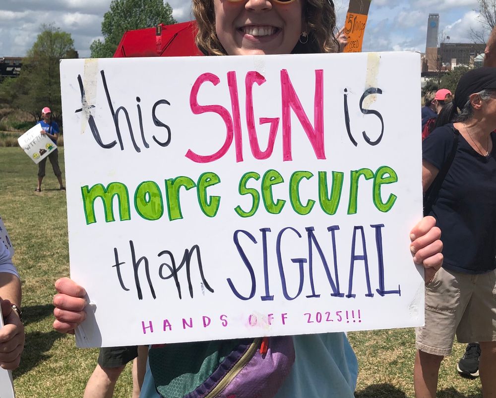 Participant holding sign during Hands Off rally in Birmingham, Alabama on April 5. 