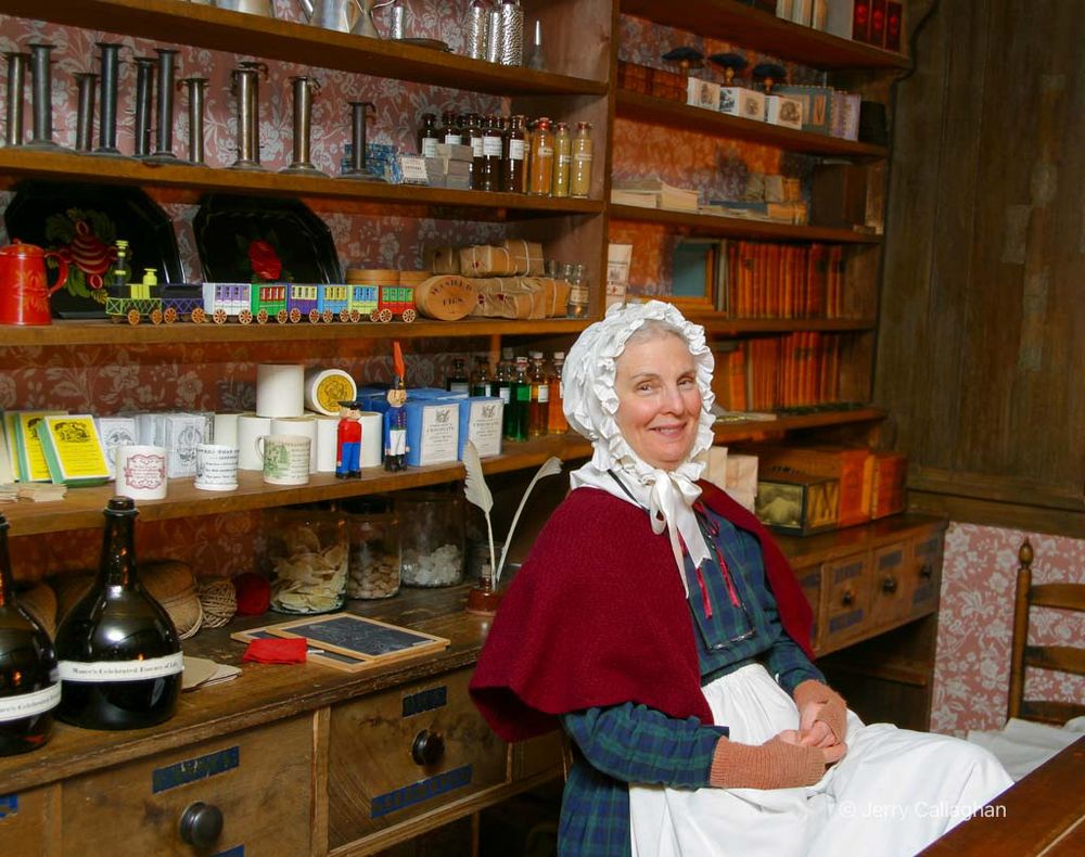 At your service
A woman in period clothing tends store at the Old Sturbridge Village in Massachusetts.  The goods lining the sleeves are what would have been for sale in the 1830’s.

