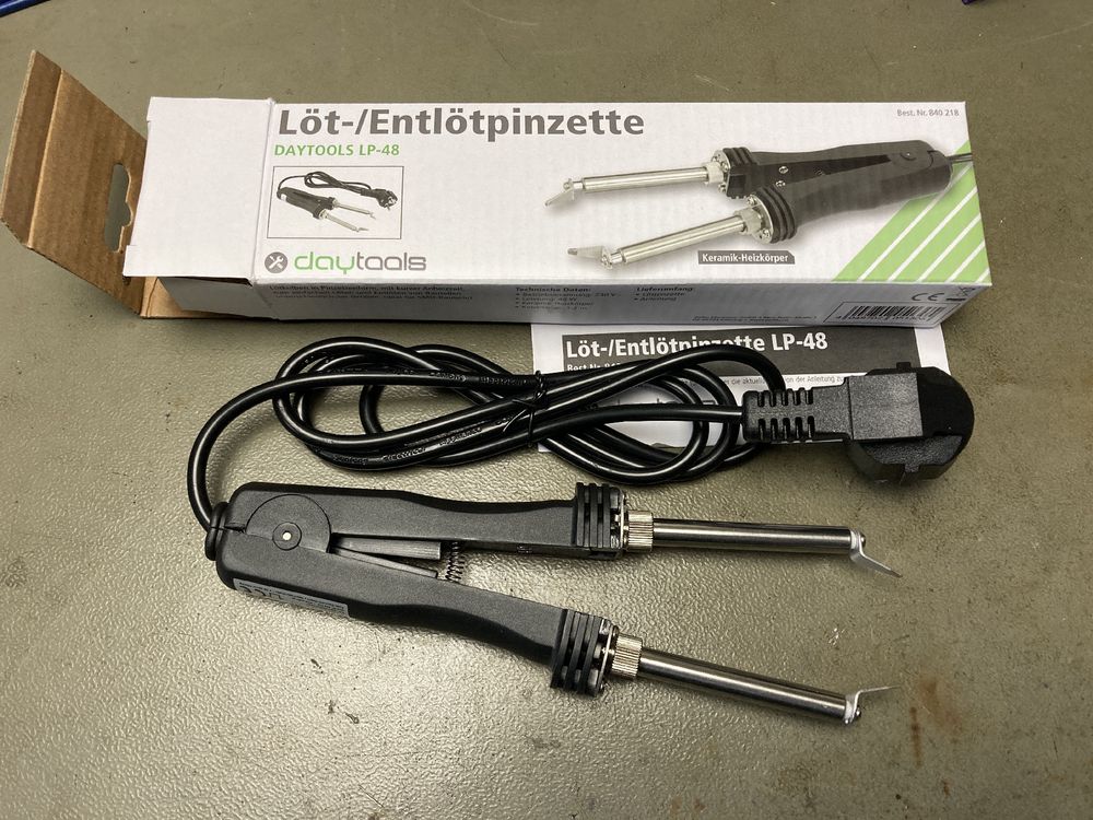 Cheapo soldering tweezers with a European mains plug and the box they came in. It’s the "Entlötpinzette LP-48", available for very little money from various sources here in Germany.
