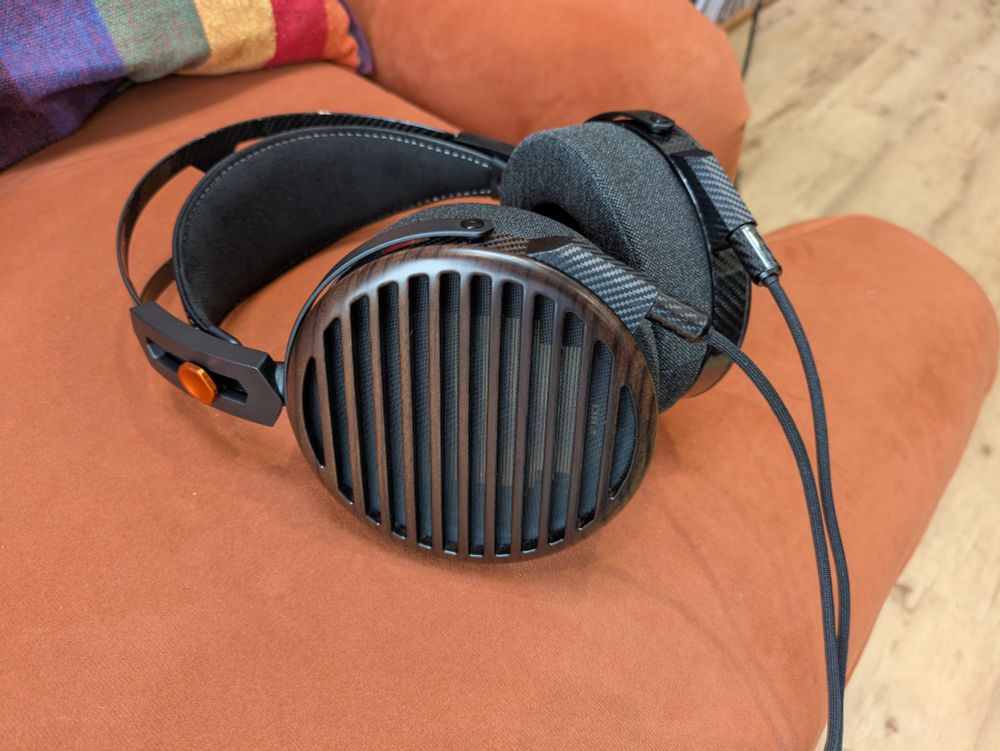 FiiO FT7 headphones lounging nonchalantly on some kind of 70s throwback "burnt orange" sofa