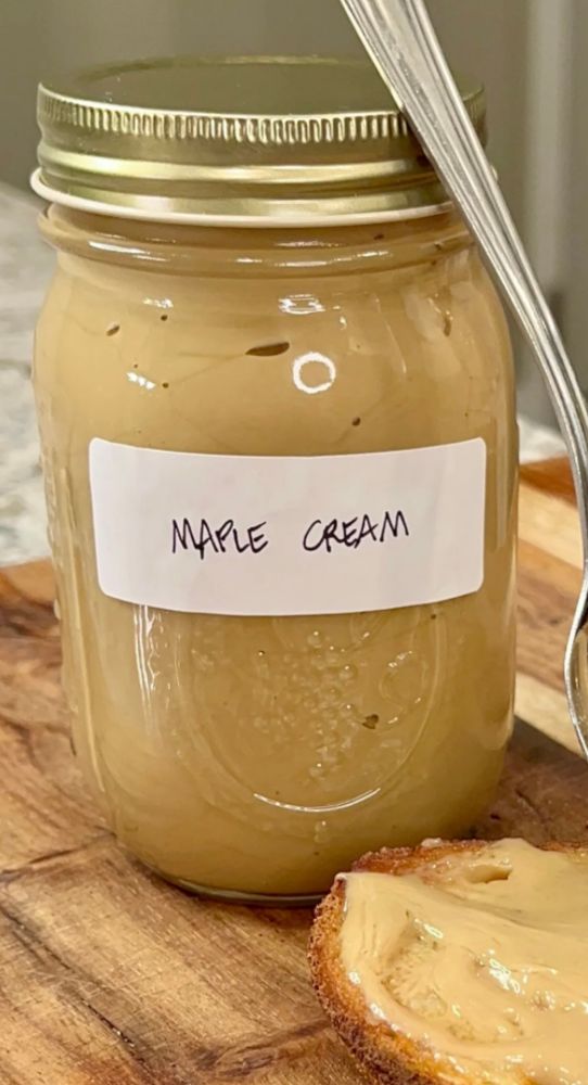 A mason jar of freshly made maple cream with a label on the front that says, “MAPLE CREAM.”