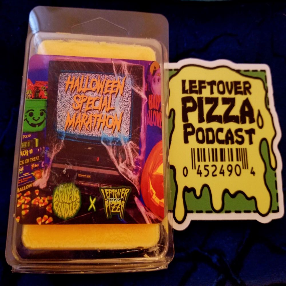 An orange wax melt in packaging showing nostalgic 90s Halloween merchandise called Halloween Special Marathon, next to a green slime themed sticker saying Leftover Pizza Podcast
