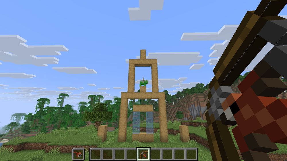 Minecraft screenshot of a recreation of angry birds, with a bird loaded into a bow.