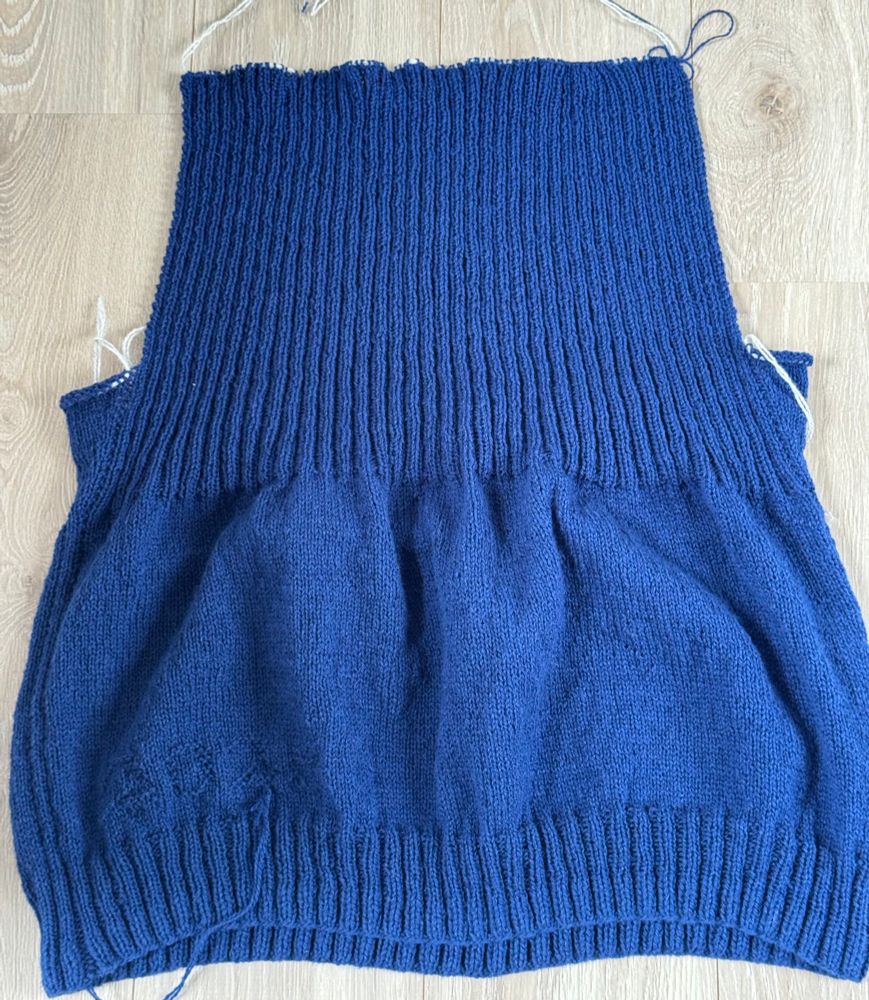 The back of a knitted piece. Darkblue wool. 