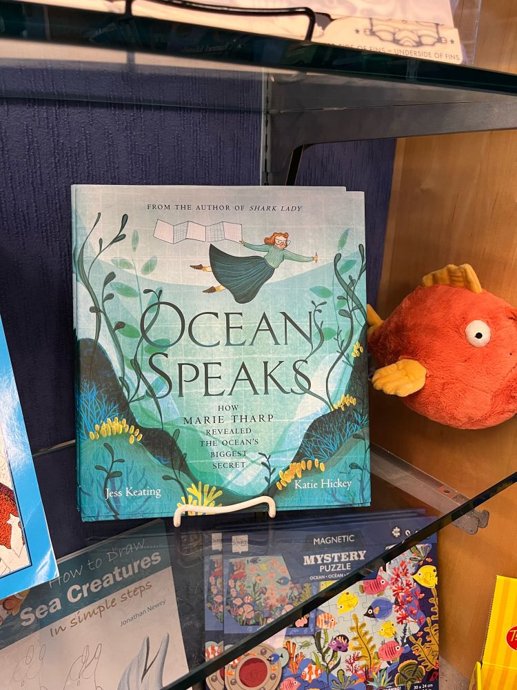 A photo of the picture book OCEAN SPEAKS: HOW MARIE THARP REVEALED THE OCEAN’S BIGGEST SECRET by Jess Keating and Katie Hickey.